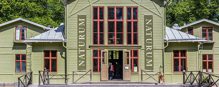 A wooden house with signs saying Naturum. Foto: Yaman Albolbol